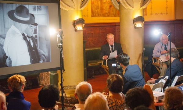 Ron with Arthur commenting before an audience.